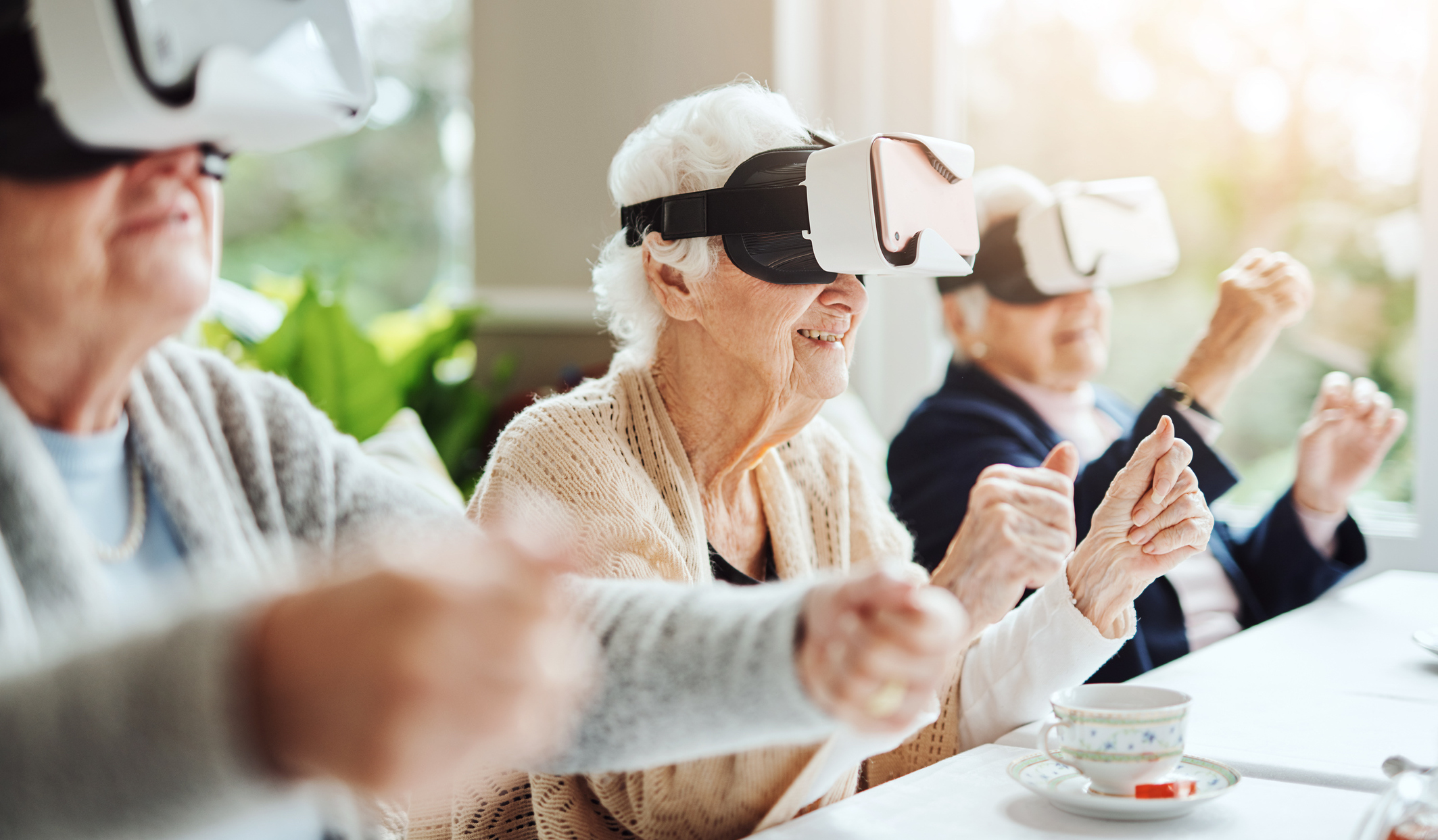 Cheerful seniors playing virtual reality game at The Respite House Adult Day Care Center for Seniors Daycare Kansas City Lenexa overland park shawnee mission merriam missouri kansas